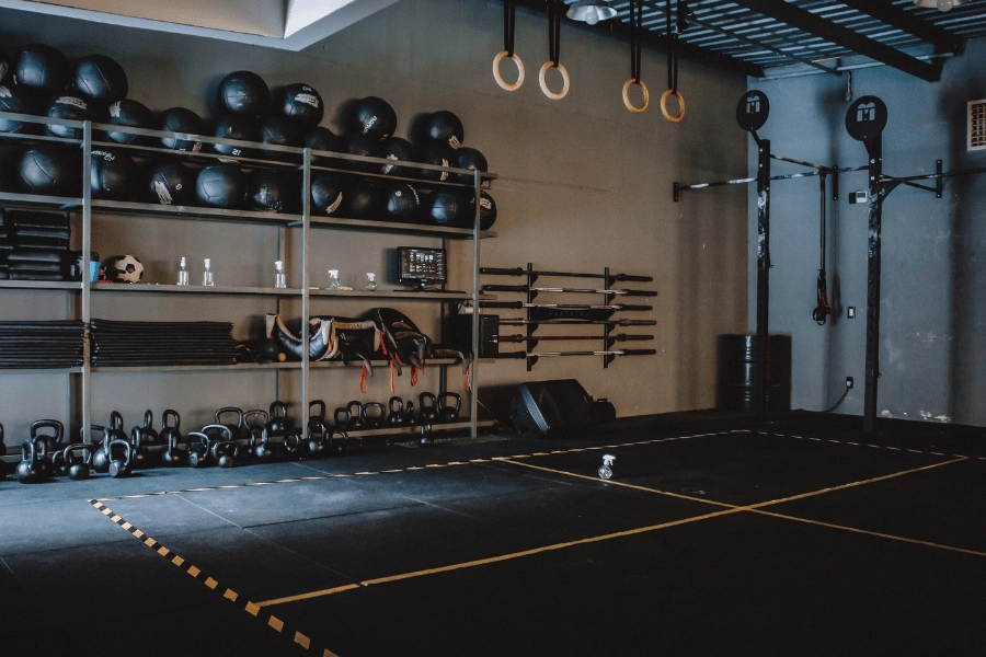 empty gym with kettlebells and weights and other gym equipment